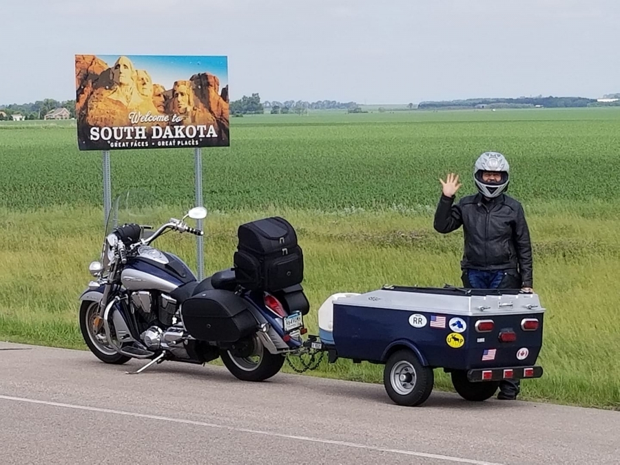 Cristy De La Cruz ’96 with a motorcycle